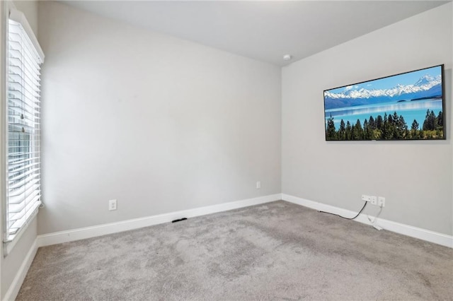 spare room featuring light colored carpet