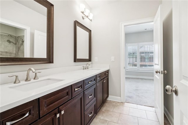 bathroom with tile patterned floors and vanity