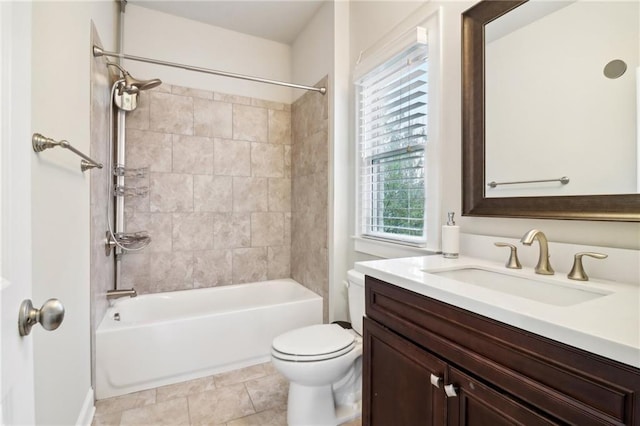 full bathroom with tile patterned floors, toilet, tiled shower / bath, and a wealth of natural light