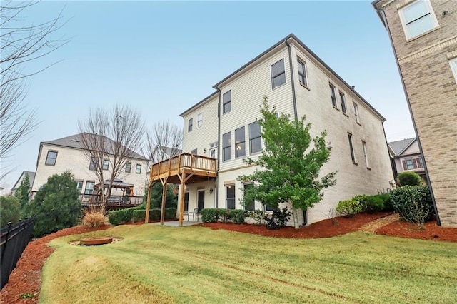 back of house with a yard and a wooden deck