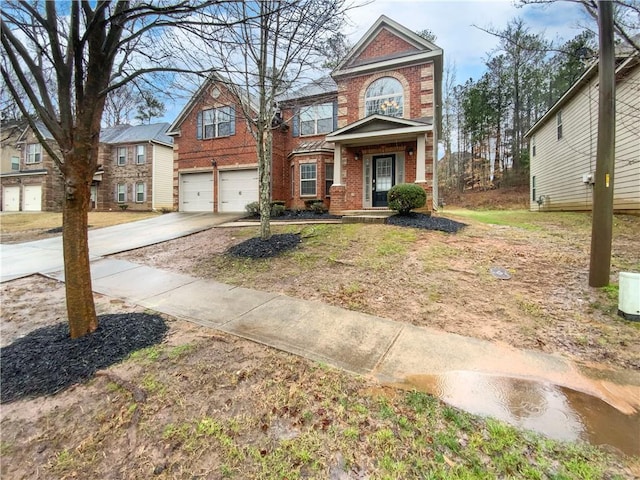 traditional home with a garage, brick siding, and concrete driveway