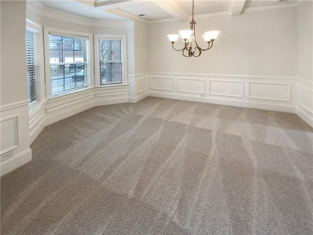 carpeted empty room with beam ceiling, a decorative wall, a notable chandelier, and crown molding