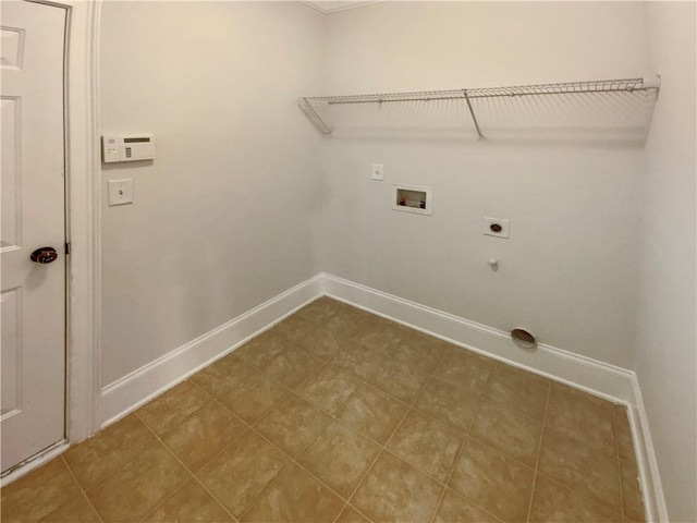 clothes washing area with baseboards, hookup for an electric dryer, hookup for a washing machine, and laundry area