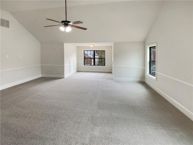 unfurnished living room with visible vents, a ceiling fan, carpet, baseboards, and vaulted ceiling