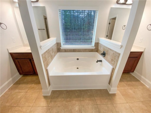 full bathroom with tile patterned floors, baseboards, a bath, and vanity