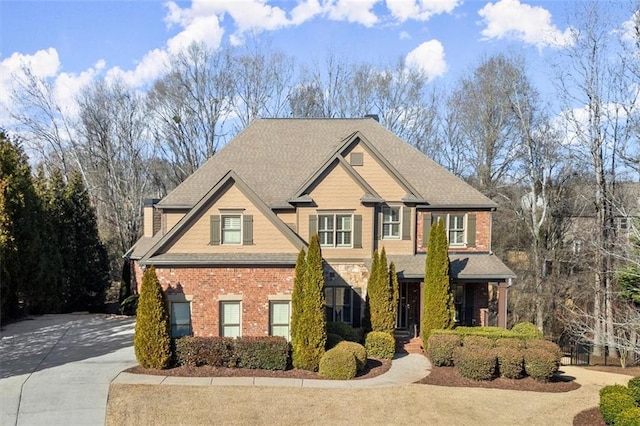 craftsman-style home featuring brick siding