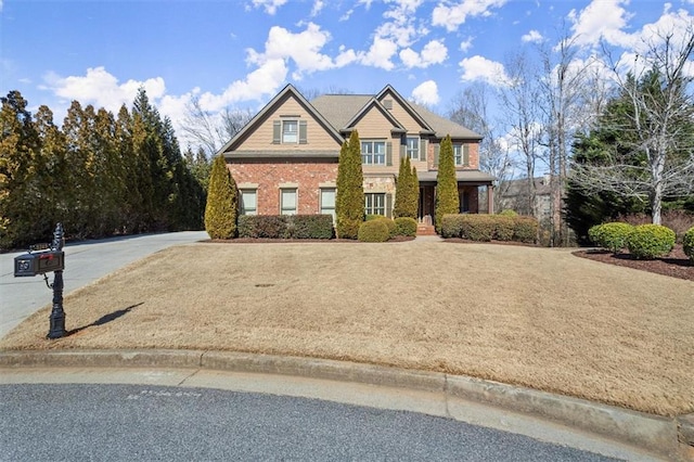 craftsman-style house featuring brick siding