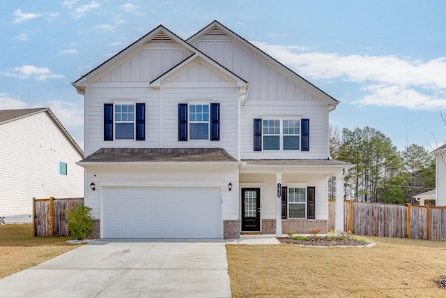 view of front of home with a front yard and a garage