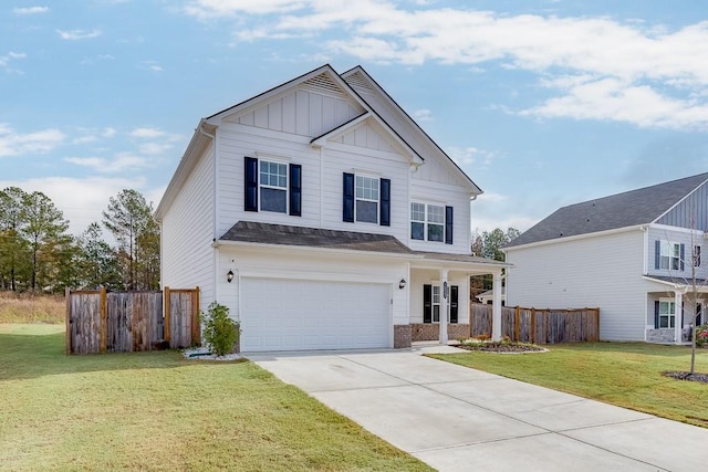 view of front of home with a front yard and a garage