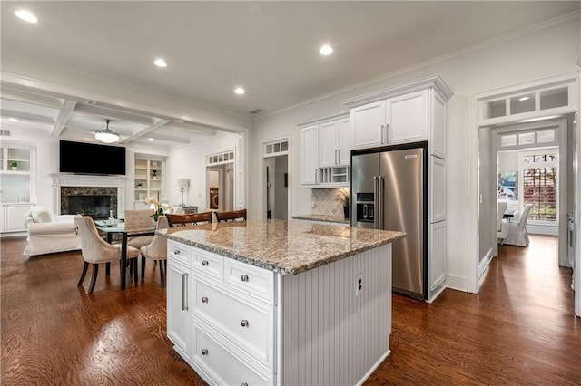 kitchen featuring dark wood-type flooring, high quality fridge, coffered ceiling, and a kitchen island