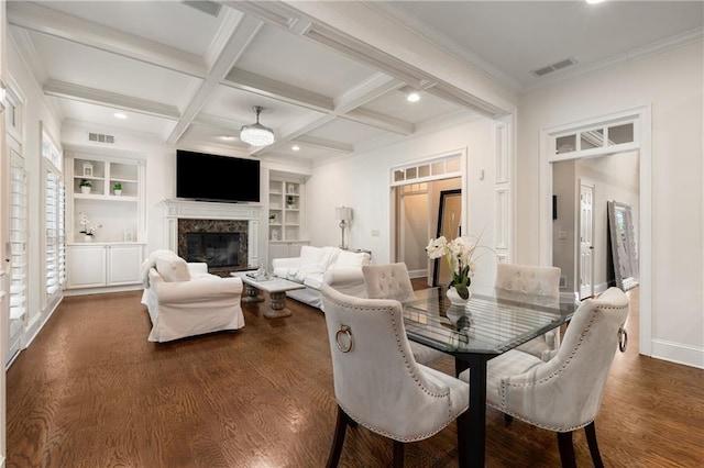 dining space with beam ceiling, visible vents, coffered ceiling, and built in features