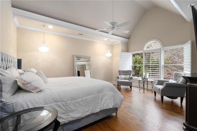 bedroom with visible vents, high vaulted ceiling, wood finished floors, crown molding, and baseboards