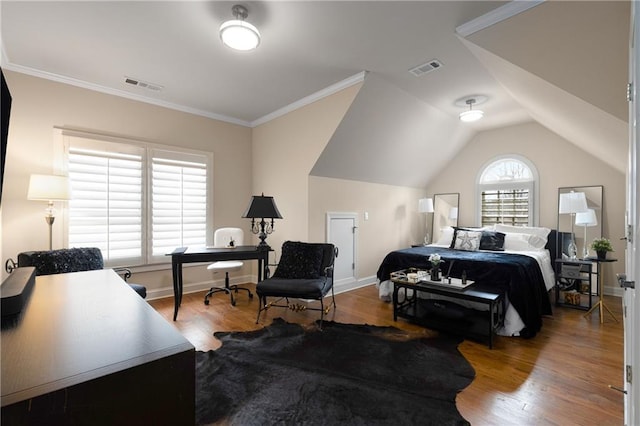 bedroom with visible vents, lofted ceiling, and wood finished floors