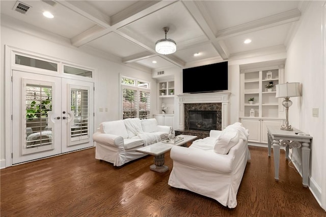 living area with beam ceiling, french doors, visible vents, and a wealth of natural light