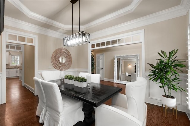 dining space with a tray ceiling, dark wood-style floors, and ornamental molding