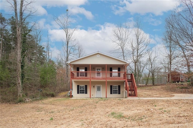 view of front facade featuring stairs and a wooden deck