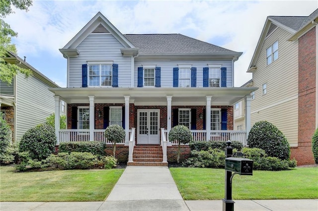 view of front facade with a front lawn and covered porch