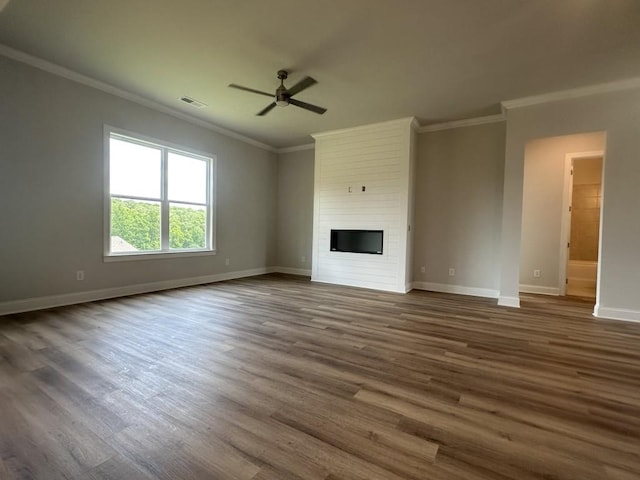 3799 Cheyenne Ln, Jefferson, GA 30549 - unfurnished living room featuring ornamental molding, a ceiling fan, baseboards, dark wood-style flooring, and a fireplace