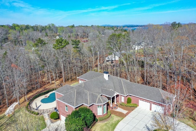 birds eye view of property featuring a view of trees