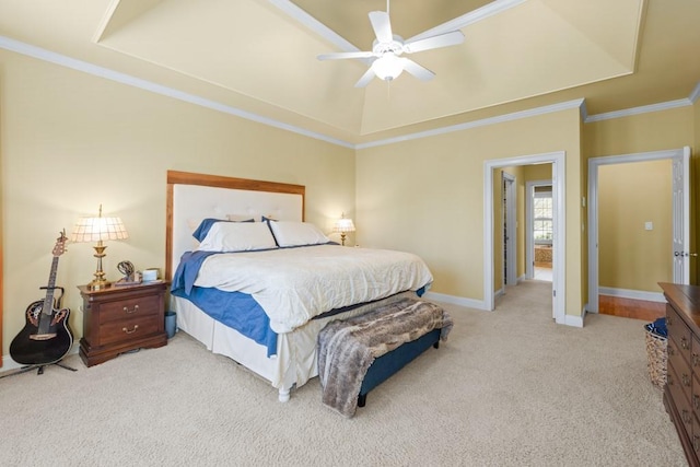 carpeted bedroom with crown molding, baseboards, a raised ceiling, and ceiling fan