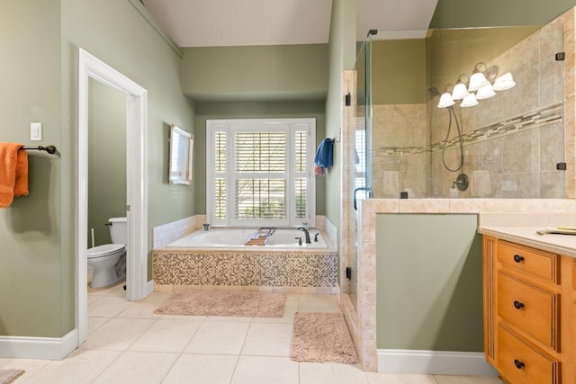 full bathroom with vanity, tile patterned floors, toilet, a shower stall, and a garden tub