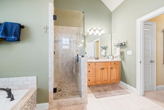 full bathroom with vanity, vaulted ceiling, tile patterned flooring, a shower stall, and a garden tub