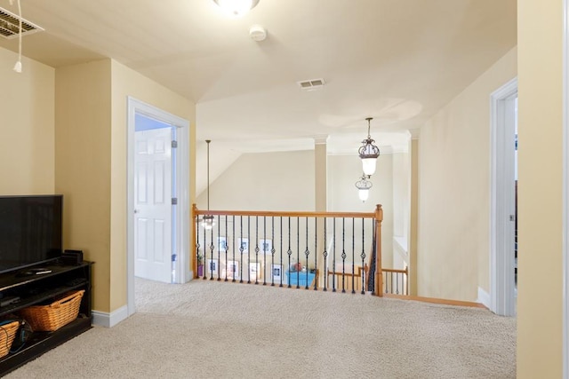 hallway featuring baseboards, visible vents, and carpet floors