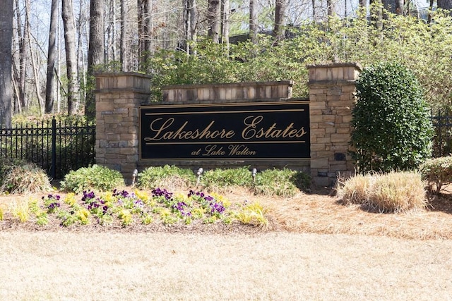 community / neighborhood sign with fence