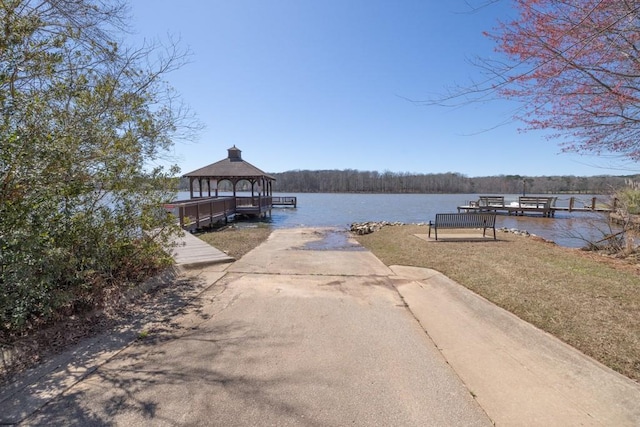 view of dock with a water view and a gazebo