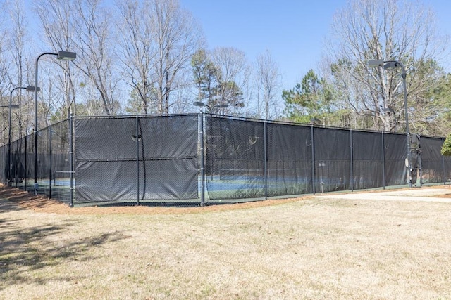 exterior space with fence and a lawn