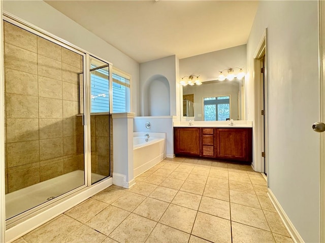 bathroom featuring tile patterned floors, a stall shower, a bath, and double vanity