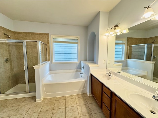 full bath featuring a bath, tile patterned flooring, a stall shower, and a sink