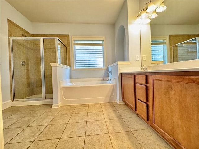 full bathroom with vanity, baseboards, tile patterned flooring, a shower stall, and a bath