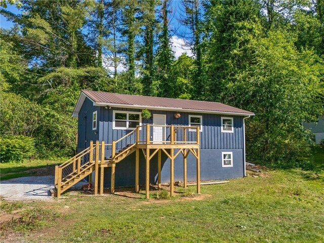 230 Pisgah Rd, Nc, NC 28901 - view of front of home featuring board and batten siding, stairway, a front lawn, and a wooden deck