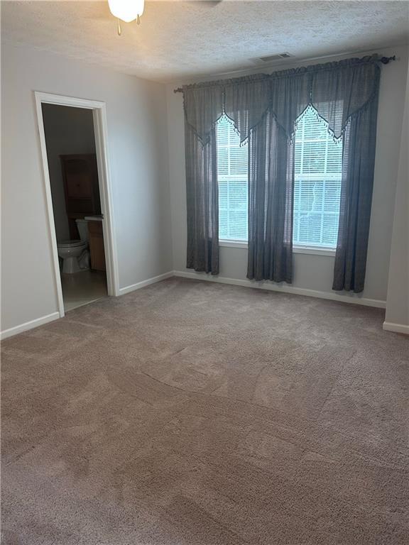 5425 Village Green Sq, Norcross, GA 30093 - carpeted spare room featuring a textured ceiling and baseboards