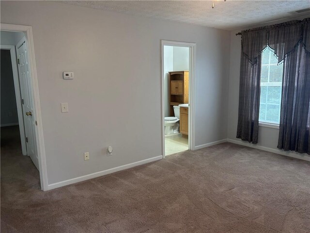 5425 Village Green Sq, Norcross, GA 30093 - spare room featuring light carpet, baseboards, and a textured ceiling