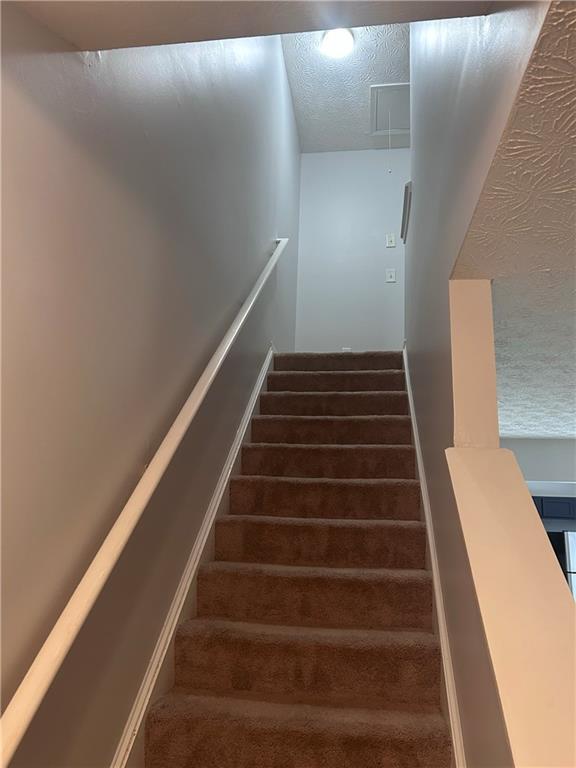 5425 Village Green Sq, Norcross, GA 30093 - stairs with attic access and a textured ceiling