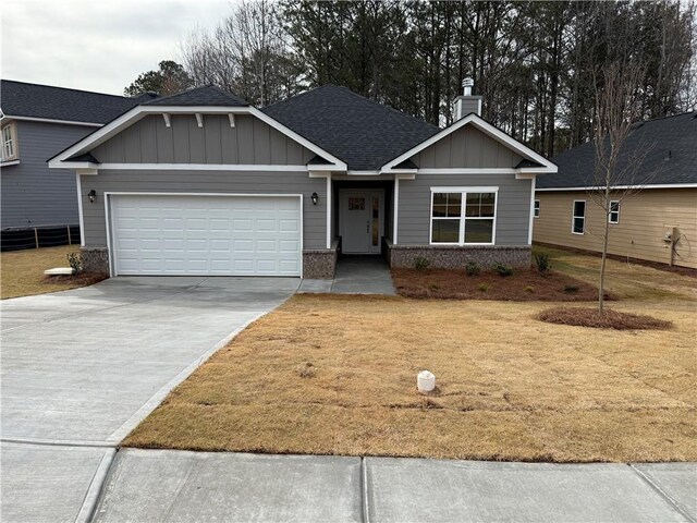 view of front of property with a front lawn and a garage