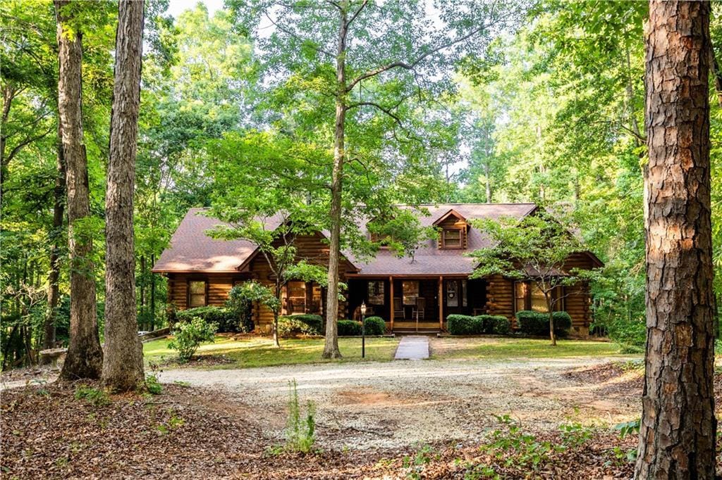 log-style house featuring covered porch