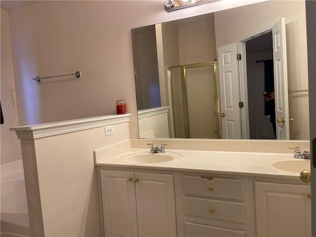 bathroom featuring vanity and an enclosed shower