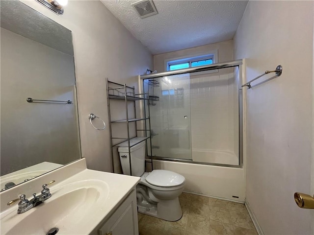 full bathroom with vanity, toilet, bath / shower combo with glass door, and a textured ceiling