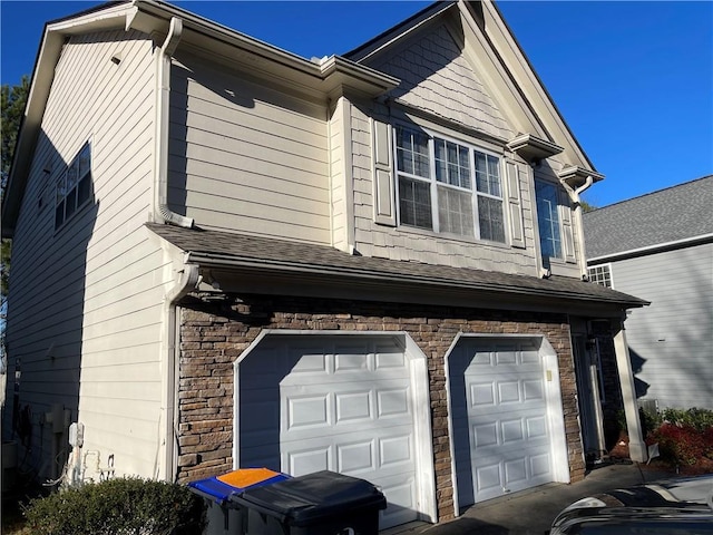 view of side of home featuring a garage