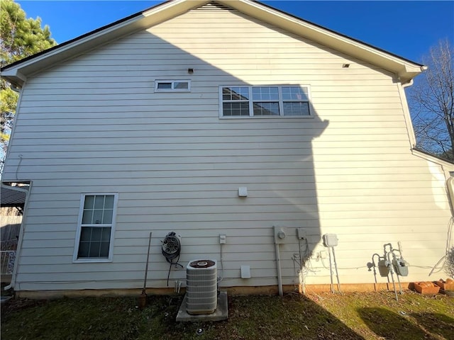 view of side of home featuring central AC