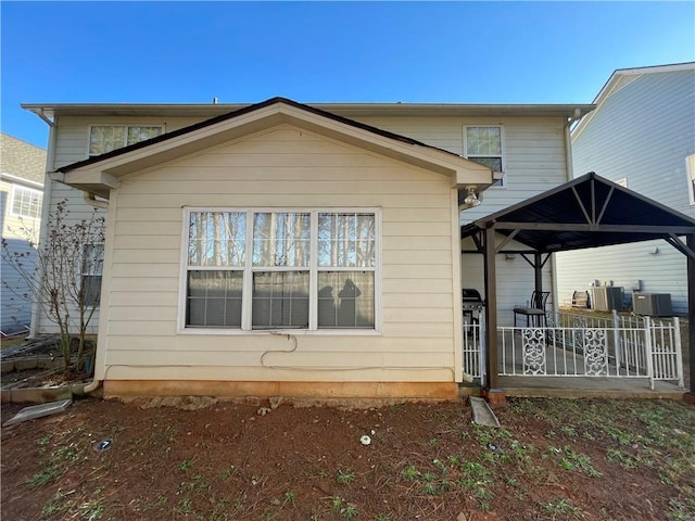 rear view of house featuring a gazebo and central AC