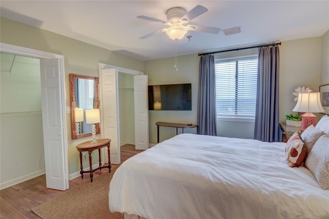 bedroom with ceiling fan and hardwood / wood-style flooring