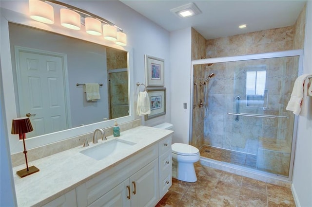 bathroom with toilet, vanity, and an enclosed shower