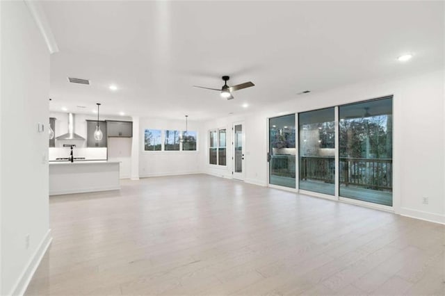 unfurnished living room featuring recessed lighting, light wood finished floors, visible vents, and a ceiling fan