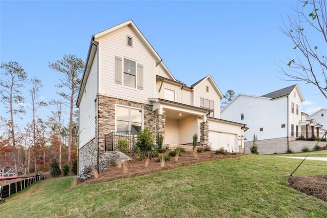 view of front of property with a garage, stone siding, and a front lawn