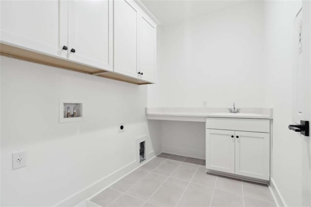 clothes washing area with baseboards, hookup for an electric dryer, cabinet space, hookup for a washing machine, and light tile patterned flooring