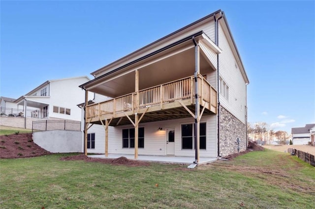 back of house featuring a yard, a patio, a deck, and fence
